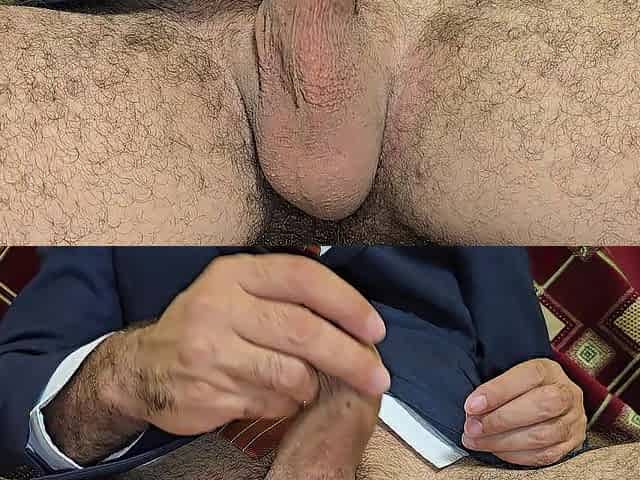 A curly guy in a dress milks a large dick with joy