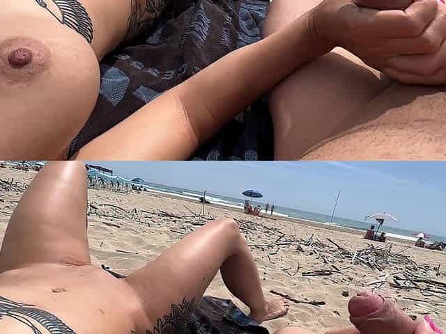 Nudist pair fingering on public beach
