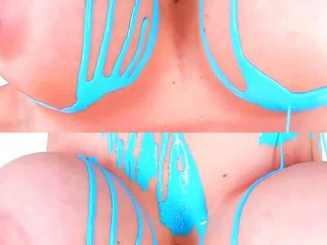 A blue haired dame poses solo with body paint
