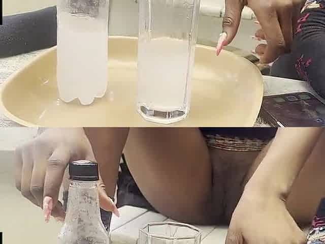 Black hotty displays her bald snatch whilst enjoying drinking