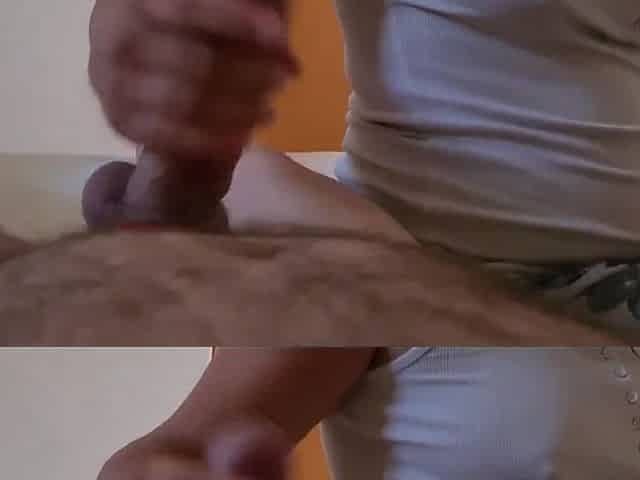 Hot clothed gal gives her coworker a tugjob whilst talking indecent to him. A lot of cum.