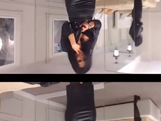 Sexy dancer in leather dress and stockings making striptease