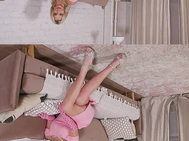 The busty blonde masturbates her bald pussy wearing sexy lingerie