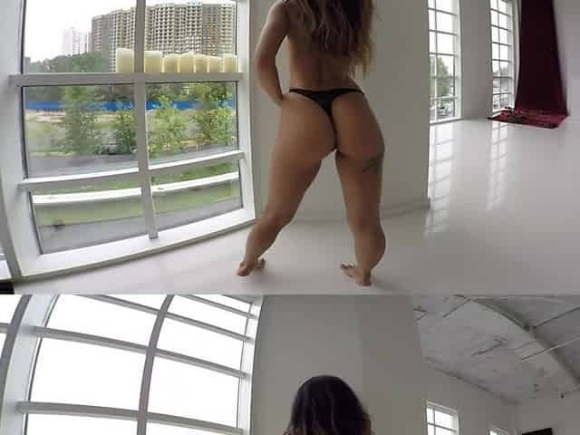 Busty, Tatted up Hottie Strips in Front of a Window